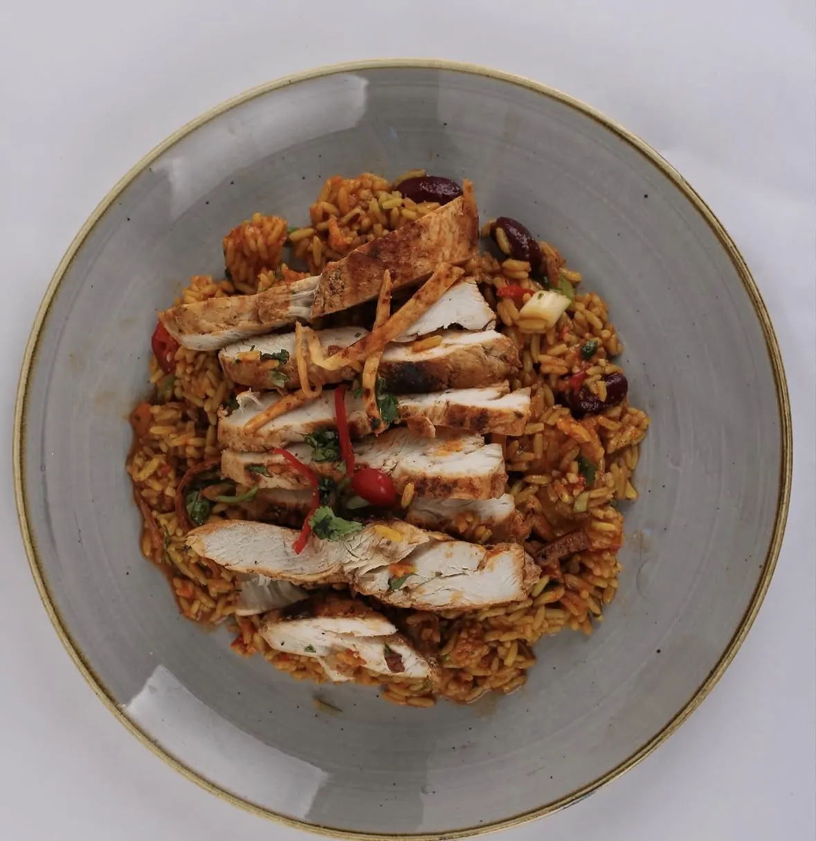 Caribbean-style grilled chicken over seasoned rice